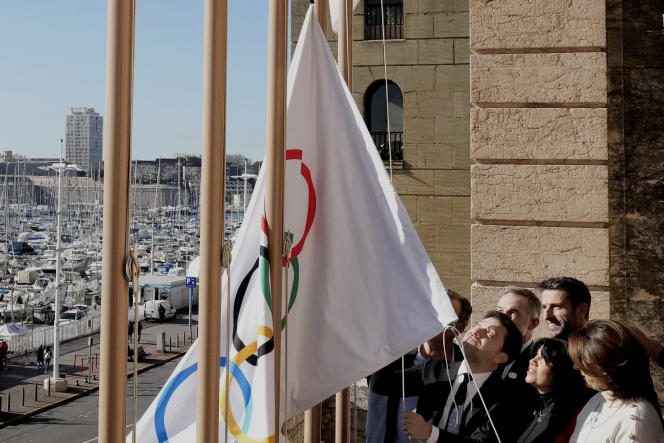 The mayor of Marseille, Benoît Payan (on the left of the group), hoists the Olympic flag, alongside Tony Estanguet (on the right), president of the organizing committee of the Paris 2024 Olympic Games, in Marseille, on February 3, 2023. 