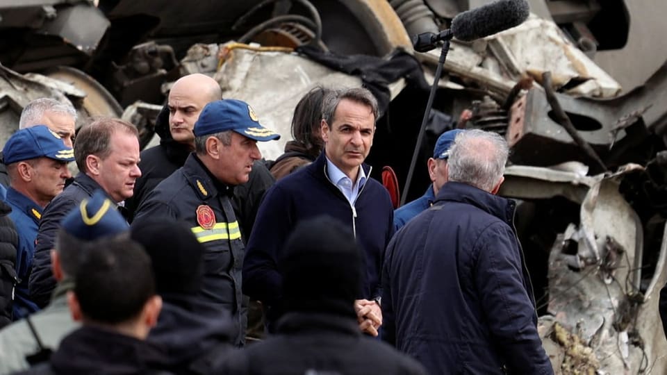 Greek Prime Minister Kyriakos Mitsotakis (middle, facing the camera) immediately traveled to the scene of the accident.