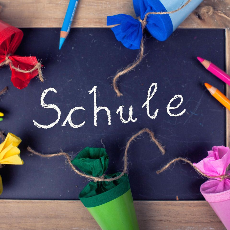 School enrollment, colorful school cones, colorful crayons, black board "School" as an inscription