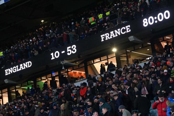 Supporters begin to leave Twickenham Stadium as the scoreboard shows the final score (10-53) of the Six Nations Championship match between England and France on March 11, 2023.