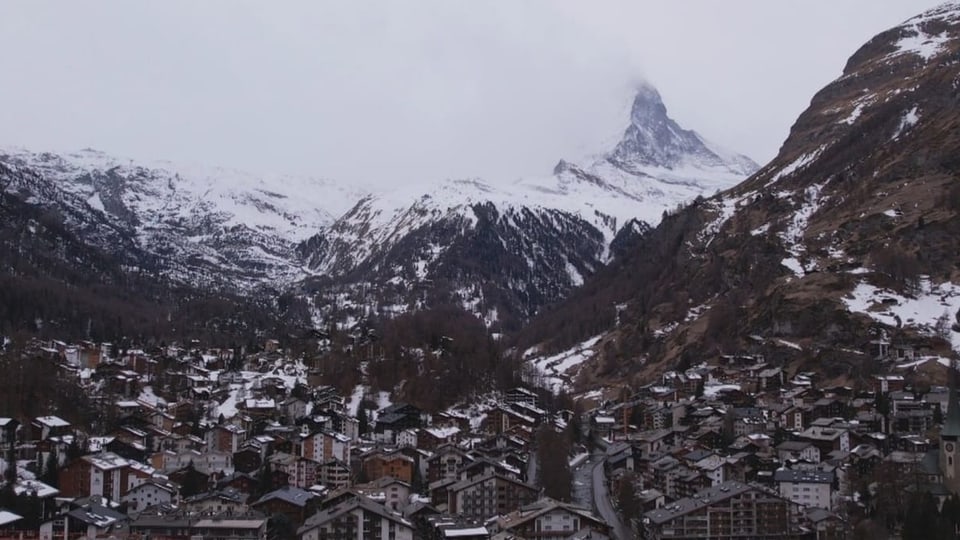 View of the village of Zermatt and the Matterhorn behind clouds