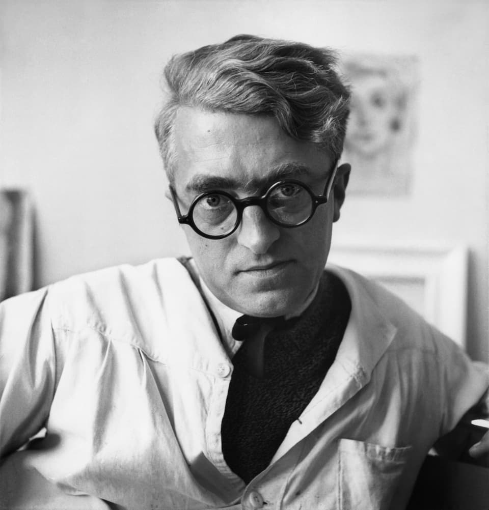Black and white image of a man with distinctive glasses