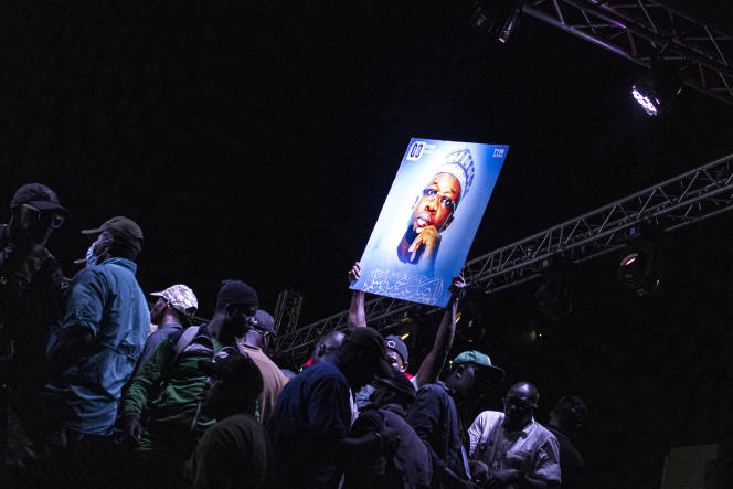 A portrait of Ousmane Sonko held up during an opposition meeting in Dakar on March 14, 2023.