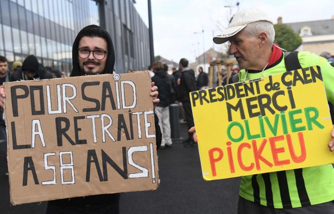 An Angers supporter holds a sign that reads 