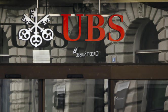 The logos of Swiss banks Credit Suisse and UBS in Zurich, March 19, 2023. (Michael Buholzer/Keystone via AP)