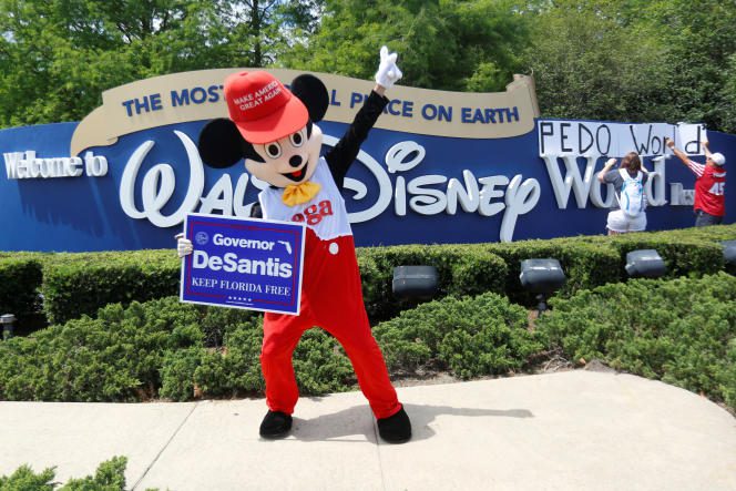 A supporter of Republican Florida Governor Ron DeSantis outside the entrance to Walt Disney World Park in Orlando on April 16, 2022. 