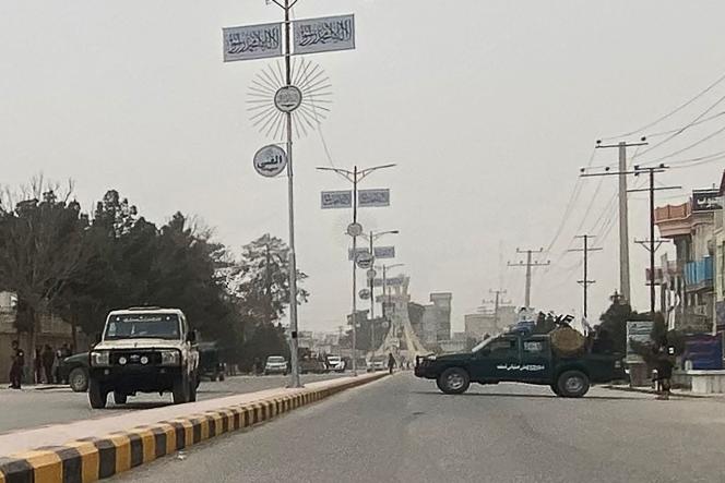 Taliban security personnel (right) block a road in Mazar-e Sharif, March 9, 2023, following an explosion in the office of the Taliban governor of Afghanistan's Balkh province. 