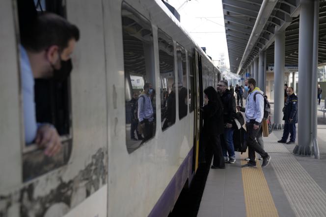 Passengers board a train at the main train station in Athens, Wednesday, March 22, 2023. 