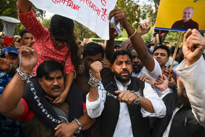 Members of the Aam Aadmi Party demonstrate against the arrest of Delhi's Deputy Chief Minister Manish Sisodia (pictured on the yellow sign) in New Delhi on February 27, 2023. 