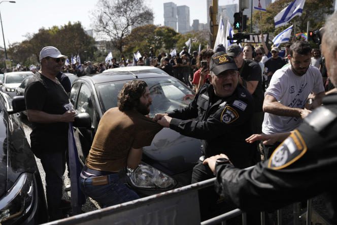 Police fight with Israelis blocking a main road to protest Prime Minister Binyamin Netanyahu's government plans to overhaul the justice system, in Tel Aviv, Israel, Wednesday, March 1, 2023.