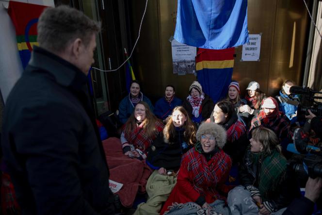 Ella Marie Haetta Isaksen (centre), spokesperson for the Sami movement, confronts Norwegian oil and energy minister Terje Aasland during a demonstration for the dismantling of two wind farms, in Oslo, on February 28 2023.