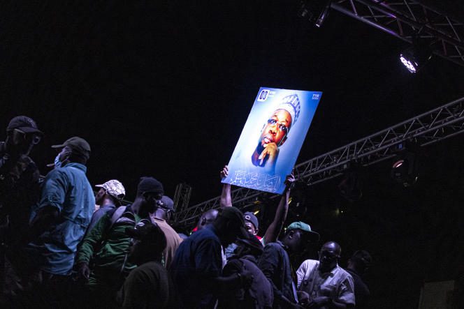 A portrait of Ousmane Sonko held up during an opposition meeting in Dakar on March 14, 2023.