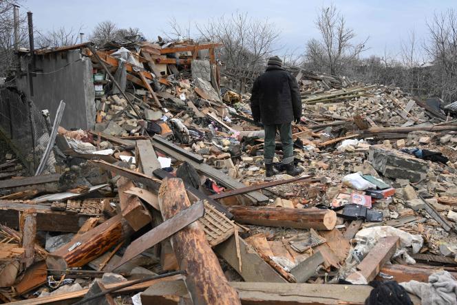 Residents of the village Velyka Vilshanytsia, located about 50 km from Lviv, search the rubble of their homes in the aftermath of a Russian attack, March 9, 2023.