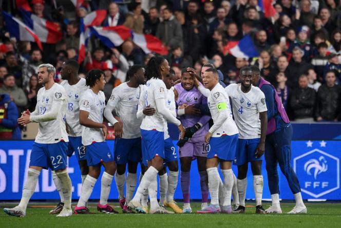 Les Bleus captain Kylian Mbappé (centre) congratulates goalkeeper Mike Maignan at the end of the Euro 2024 qualifying match between France and the Netherlands at the Stade de France in Saint-Denis on 24 March 2023. 