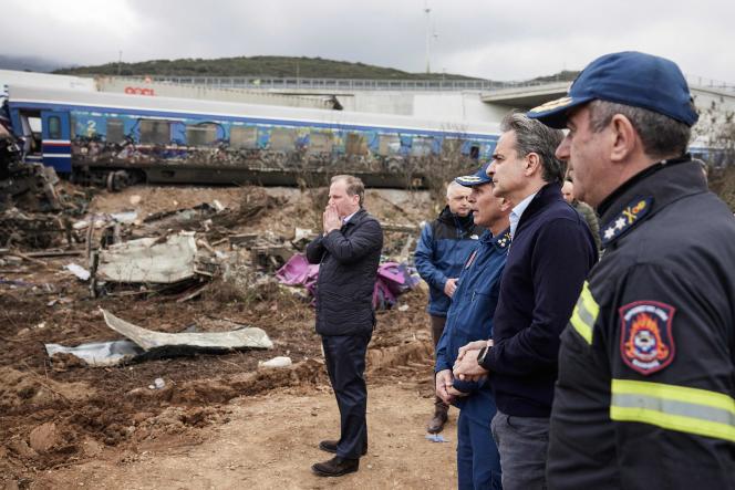 Greek Prime Minister Kyriakos Mitsotakis and Transport Minister Kostas Karamanlis visit the scene of the train crash that killed 57 people on March 1, 2023. 