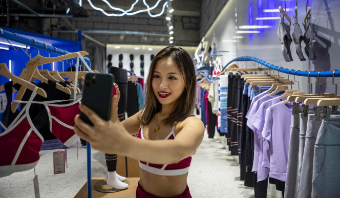 Influencer Thumper makes a video on the app Douyin, about the opening of a clothing store in Shanghai, China, August 15, 2020.