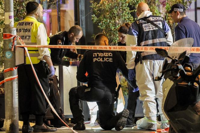 Israeli police and forensic experts inspect the scene of a shooting along Dizengoff Avenue in central Tel Aviv on March 9, 2023.