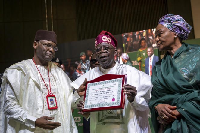 President-elect Bola Tinubu, center, with his wife Oluremi Tinubu and Independent National Electoral Commission (INEC) Chairman Mahmood Yakubu during a ceremony in Abuja, Nigeria, March 1, 2023. 