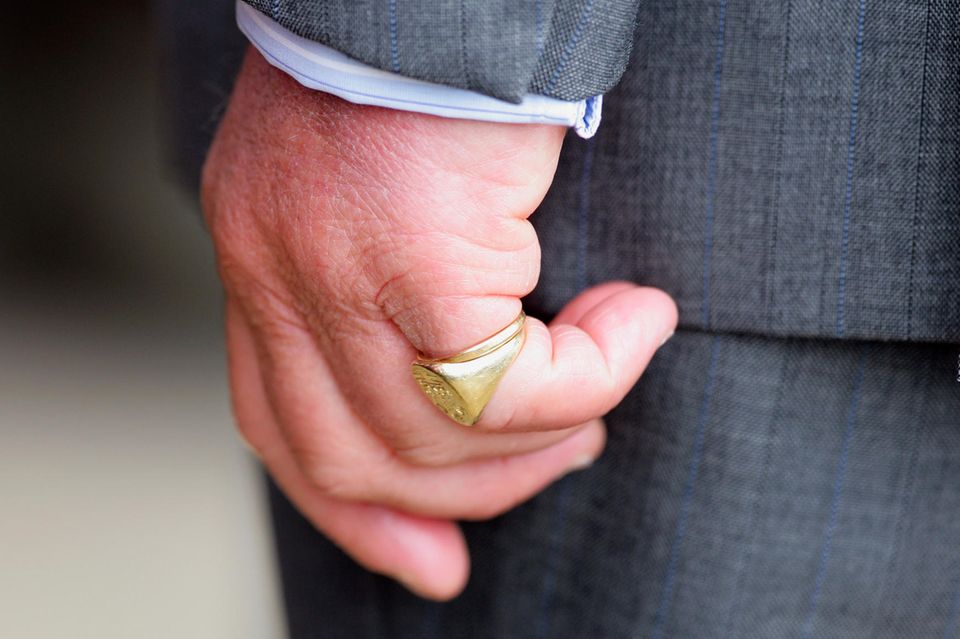 King Charles does not wear his wedding ring on his ring finger, but under his signet ring on the little finger of his left hand. 