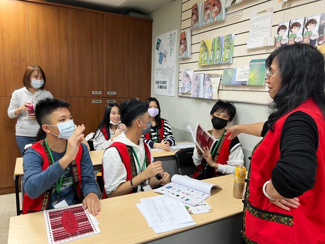 College students revise with their teacher, Nikar Namoh, before an indigenous language competition on March 18 in Taipei.