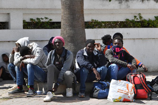 Migrants wait outside IOM headquarters in Tunis on April 11, 2023, after security forces dismantled their camp.