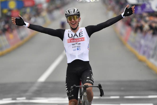 Tadej Pogacar raises his arms at the finish of the Tour of Flanders, in Oudenaarde, on April 2.