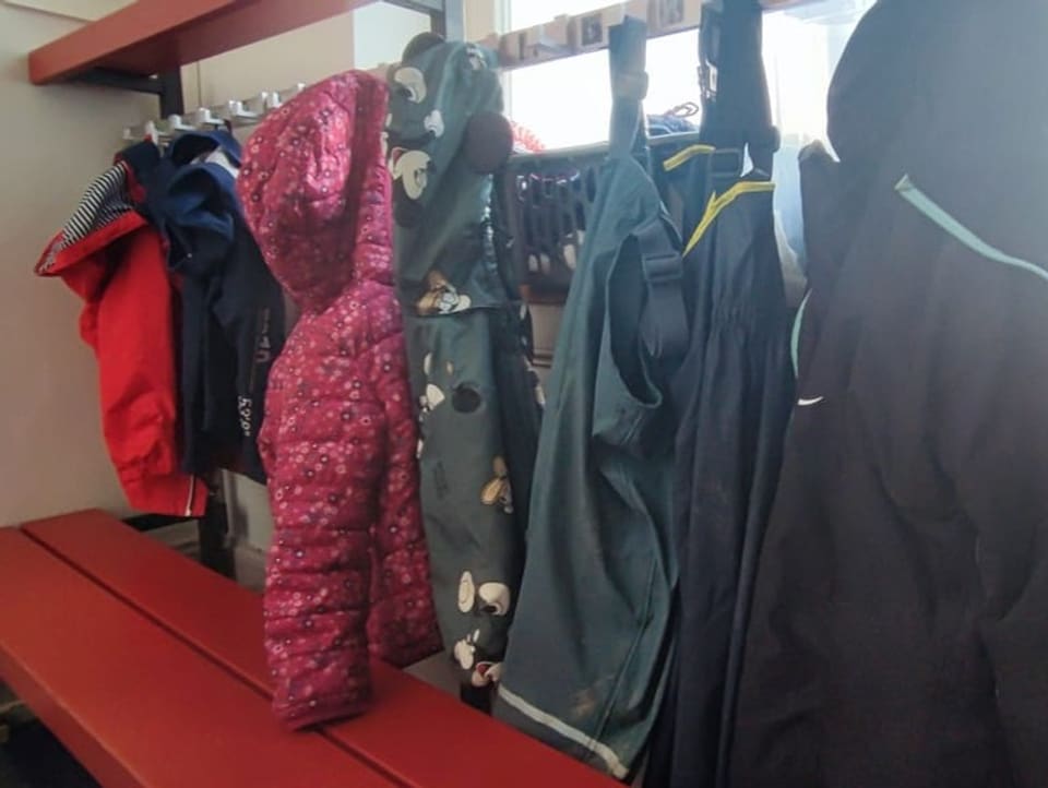Cloakroom with several children's jackets.  Up to 13 children are currently housed in the women's shelter.