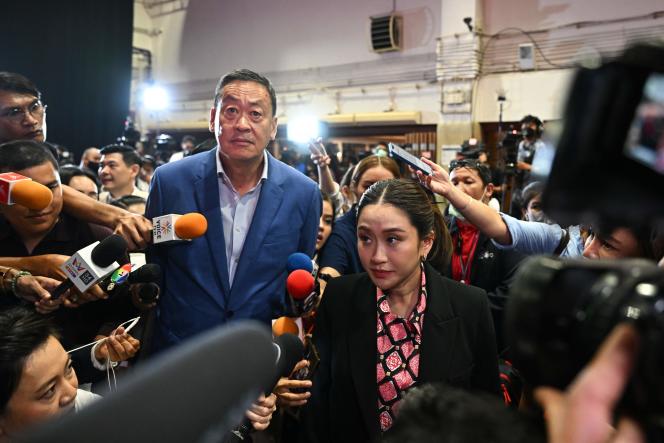 Pheu Thai Party prime minister candidates Paethongtarn Shinawatra (right) and Srettha Thavisin (left) arrive at the party's headquarters in Bangkok on May 14, 2023, after polls closed in the general election in Thailand. 