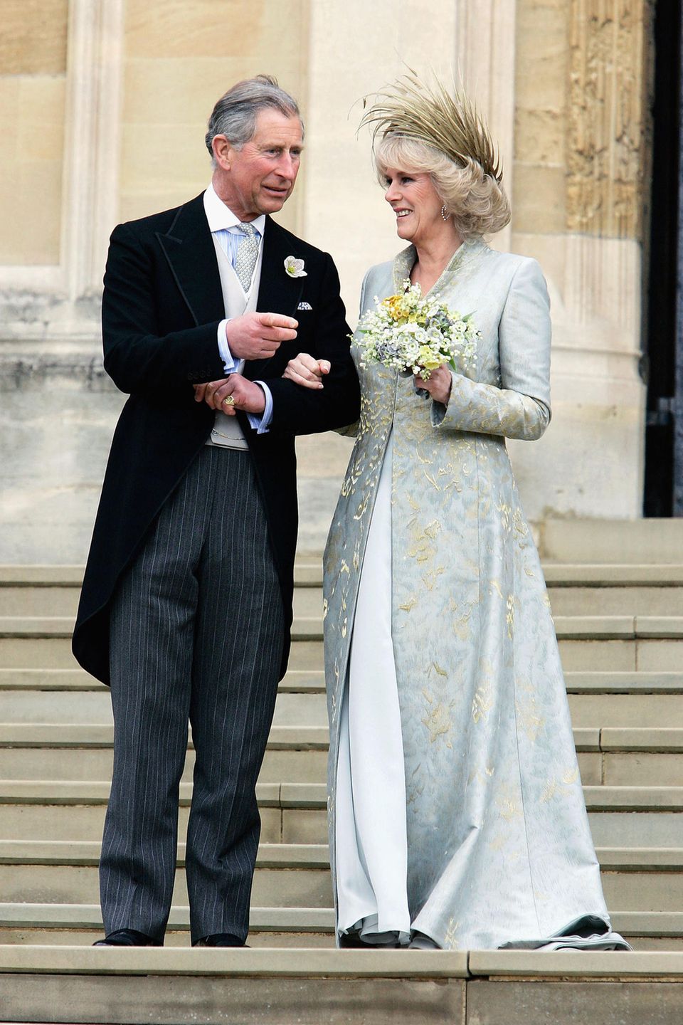 April 9, 2005 When Prince Charles was finally able to marry his great love Camilla Parker-Bowles, she was radiant in a beige-blue silk chiffon dress, over which she wore an intricately embroidered silk coat.  Philip Treacy's feather-studded hat was a real eye-catcher.