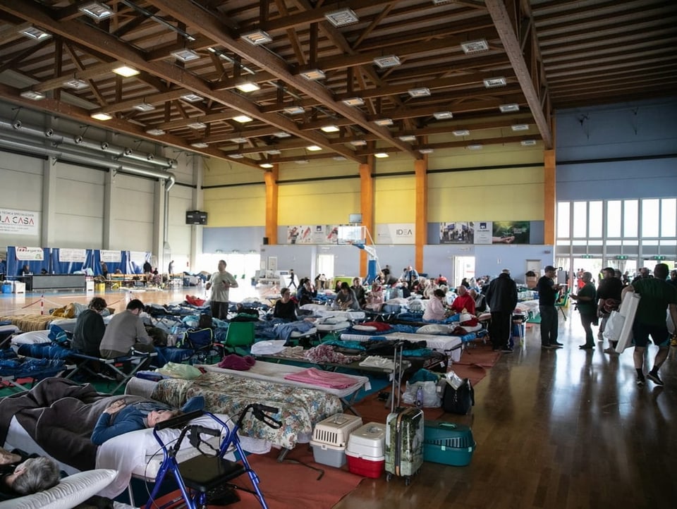 People who have become homeless in the Emilia-Romagna region seek refuge in an emergency shelter.