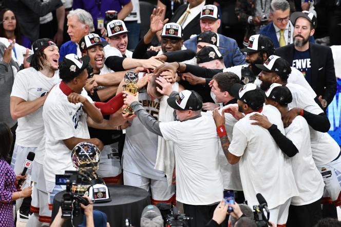 The Denver Nuggets congratulate Nikola Jokic after lifting the NBA Western Conference Champions Trophy on May 22, 2023, in Los Angeles, USA.