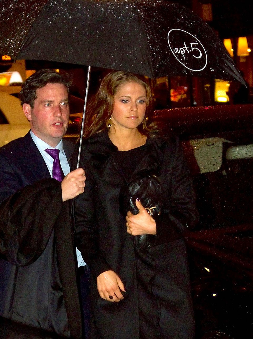 Chris O'Neill protects Princess Madeleine from the rainy New York weather.  They will then attend a concert by the Swedish Youth Orchestra on January 26, 2012 at Carnegie Hall.