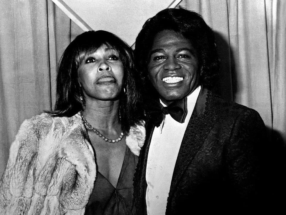 Tina Turner and James Brown in a gala dress and black suit