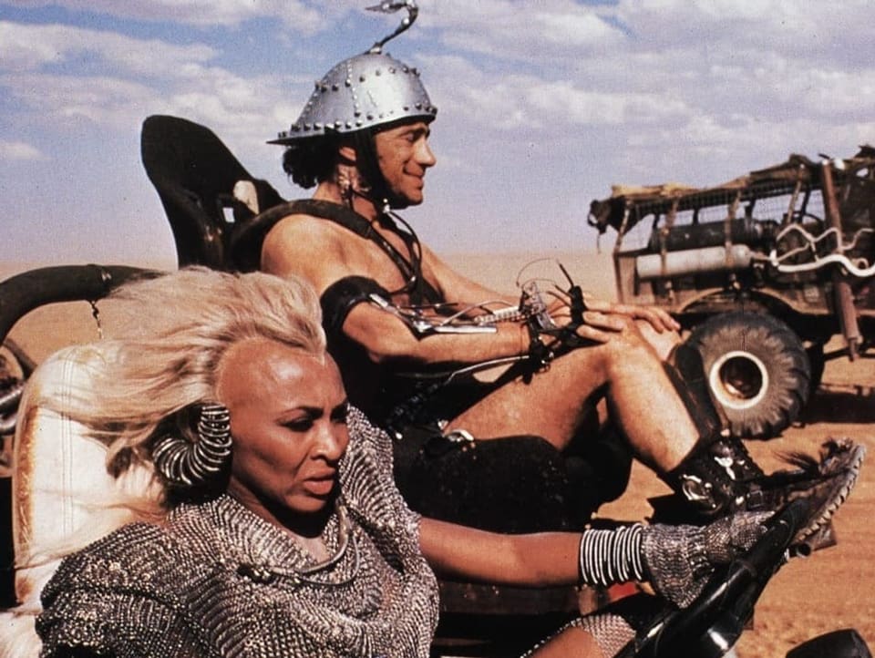 Tina Turner in costume while driving a go-kart on set