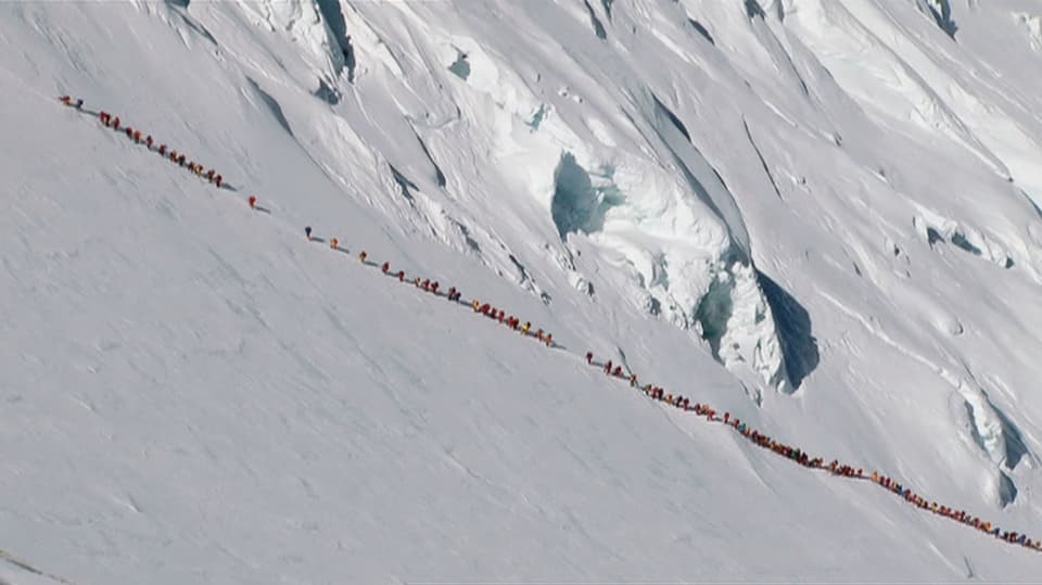 Long lines of people on the glacier.