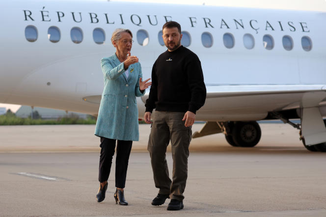 Ukrainian President Volodymyr Zelensky is greeted by French Prime Minister Elisabeth Borne upon his arrival at Villacoublay Air Base, southwest of Paris, Sunday, May 14, 2023.