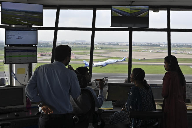 Air traffic controllers monitor the takeoff of a plane from Chennai International Airport, India, October 20, 2022. 