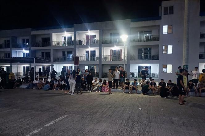 This photo, taken on May 4, 2023 and transmitted on May 6 by the Philippine National Police's Cybercrime Unit, shows victims of human trafficking from Asian countries after a police raid, in Mabalacat, in the province of Pampanga, north of Manila. 