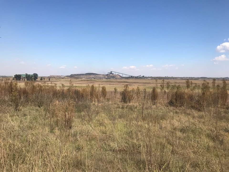 Shot of a landscape in South Africa.  Coal mining can be seen in the center of the image.