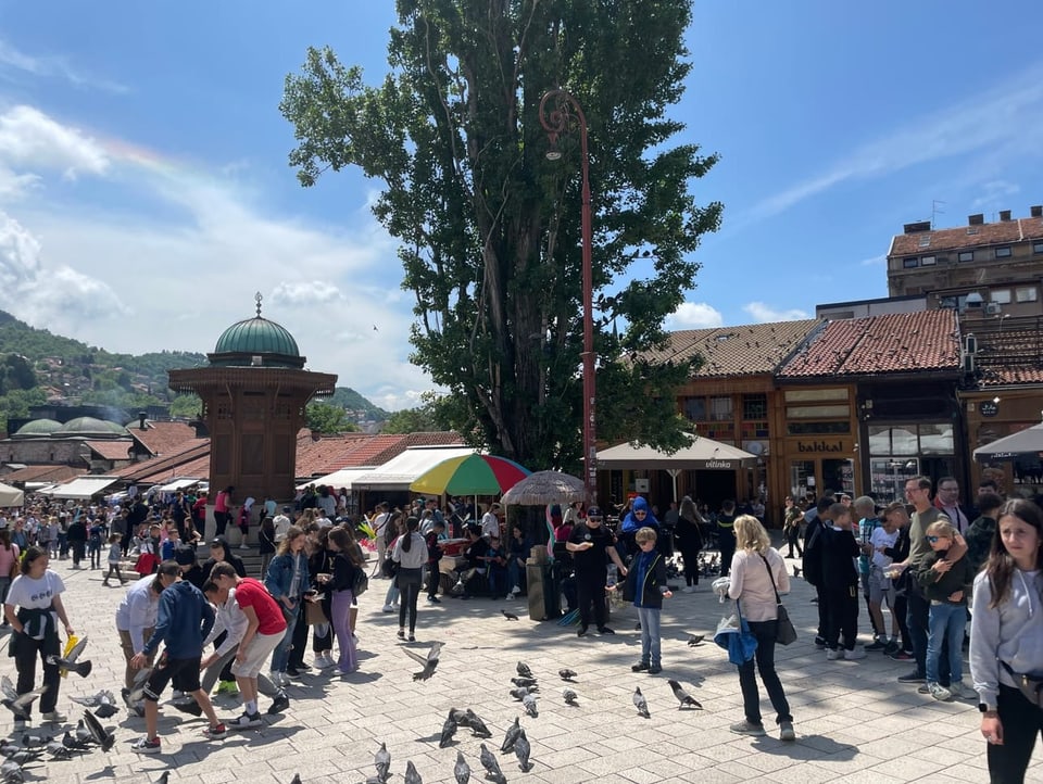 People crowd the square around the Sebilj fountain in Sarajevo.