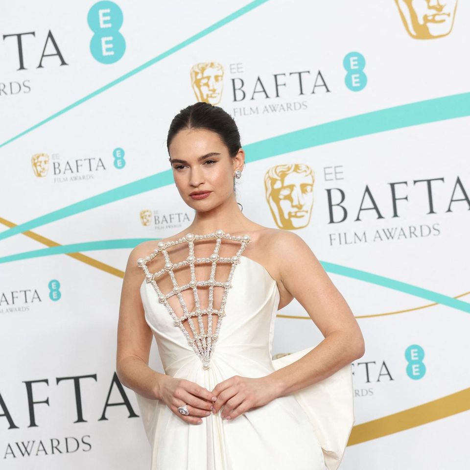 Lily James wears a shell-like beaded dress to the British Academy Film Awards. 