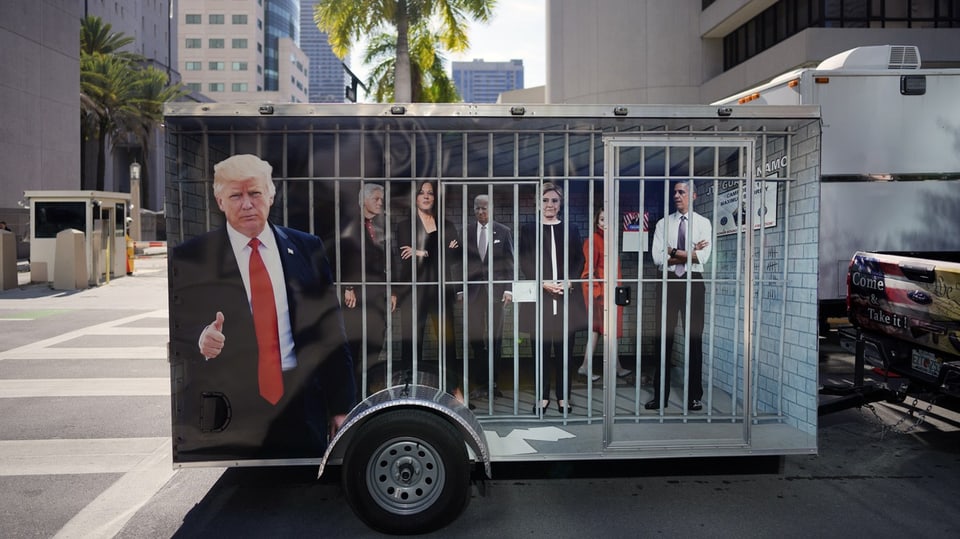 A car trailer with the image of several people in prison