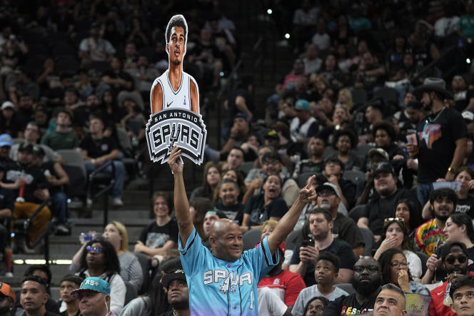 A Spurs fan holds a Victor Wembanyama sign in San Antonio on June 22, 2023.