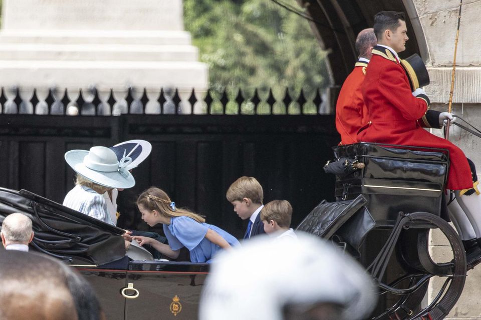 Princess Charlotte looks into Queen Camilla's purse