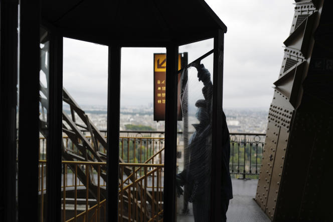 An employee in charge of cleaning during the reopening of the top floor of the Eiffel Tower, in Paris, on July 15, 2020.