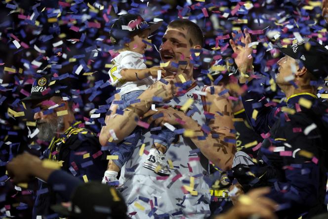   Denver Nuggets' Nikola Jokic celebrates with his daughter after winning the NBA Finals against the Miami Heat at the Ball Arena in Denver, Colorado on June 12, 2023.