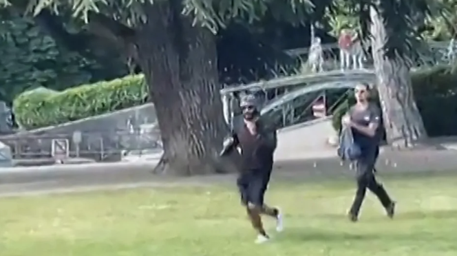 A screenshot from an amateur video of the knife attack in Annecy, showing Henri d'Anselme chasing the assailant, June 8, 2023.