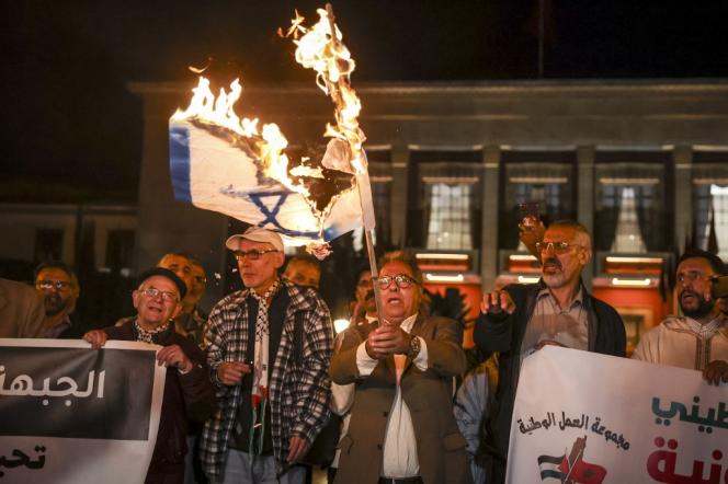 The Israeli flag is burned in Rabat during a demonstration in support of the Palestinian cause, March 30, 2023. 