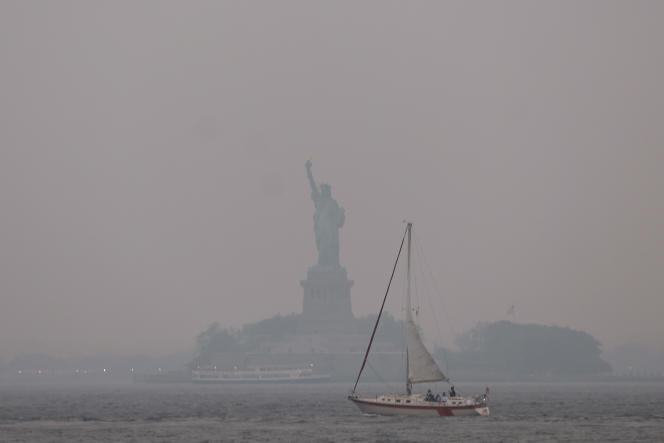 The Statue of Liberty is shrouded in a reddish haze due to wildfires in neighboring Canada, in New York, June 6, 2023.