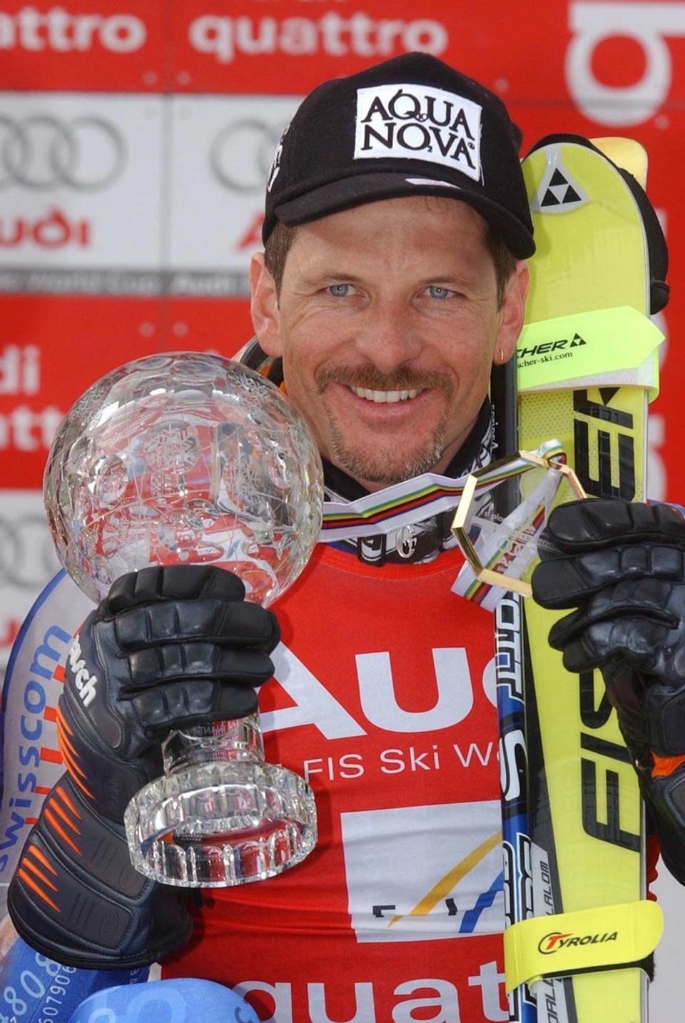 Man posing with skis and crystal ball